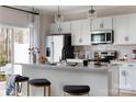 Modern kitchen with stainless steel appliances, white countertops, and pendant lighting at 2028 Endeavor Run, Charlotte, NC 28269