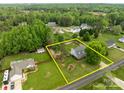Aerial view showcasing the property's expansive lot, mature trees, and fenced backyard at 230 Castle Keep Rd, Salisbury, NC 28146