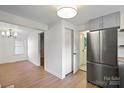 Spacious area with stainless steel refrigerator, hardwood floors, and bright lighting at 300 N Ervin Ave, Newton, NC 28658