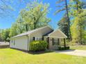 Cozy single-story house showcases a well-maintained lawn and traditional architecture with a covered front entry at 379 Maiden Sw Ln, Concord, NC 28025
