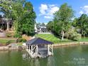 Beautiful backyard featuring a boat dock with covered storage and manicured lawn at 4039 5Th Nw St, Hickory, NC 28601