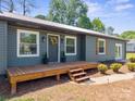 Charming home with a wooden deck, gray siding, white trim, and a welcoming front entrance at 4115 Conley St, Newton, NC 28658