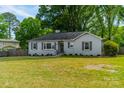 Attractive single-story house featuring a well-kept lawn and mature trees at 4544 Craig Ave, Charlotte, NC 28211