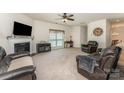 Inviting living room with plush seating, a cozy fireplace, and a large window for natural light at 4861 Samuel Pinckney Dr, Belmont, NC 28012