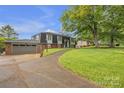 Charming two-story home with brick facade, manicured lawn, and mature trees creates a welcoming curb appeal at 4935 Kennedy St, Hickory, NC 28602