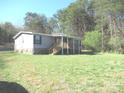 Cozy home with stone accents and a welcoming covered porch, nestled among trees at 5180 Macedonia Church Rd, Vale, NC 28168