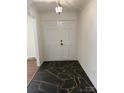 Entryway featuring double doors and unique stone tile flooring at 629 Belmorrow Dr, Charlotte, NC 28214