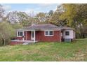 Charming brick ranch home featuring a cozy front porch and well-maintained lawn at 668 Riverside Dr, Lincolnton, NC 28092