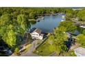 Stunning aerial view of a lakeside home with lush landscaping and access to the serene waters at 7851 Green Cove Ct, Denver, NC 28037