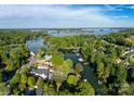 Expansive aerial view of a lake community with homes nestled among lush greenery and waterfront access at 7851 Green Cove Ct, Denver, NC 28037