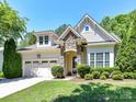 Inviting home with stone archway, attached two-car garage and beautifully landscaped front yard at 8708 Soaring Eagle Ln, Waxhaw, NC 28173