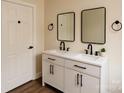 Modern bathroom with double vanity, sleek black hardware, and stylish rectangular mirrors at 905 Gantt St, Kings Mountain, NC 28086
