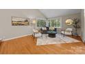 Bright living room with hardwood floors, large windows, and stylish decor at 9310 Hunting Ct, Matthews, NC 28105