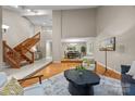 Spacious living room featuring hardwood floors, a staircase, and an open layout at 9310 Hunting Ct, Matthews, NC 28105