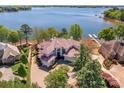 A stunning lakefront estate with lush landscaping, a private dock, and beautiful sunset views at 102 Eastham Ct, Mooresville, NC 28117