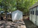Storage shed providing ample space for gardening tools and equipment, conveniently located near the home at 104 Powder Horn Trl # C92, Mount Gilead, NC 27306