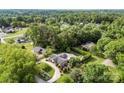 Sprawling aerial view of a home surrounded by lush greenery and mature trees at 11 Secrest Ext, Belmont, NC 28012