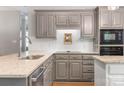 Beautiful kitchen with gray cabinets, granite countertops, and stainless steel appliances at 110 River Wood Dr, Fort Mill, SC 29715