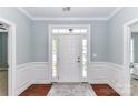 Foyer with hardwood floors and white molding at 11123 Bailey Park Nature Dr, Cornelius, NC 28031