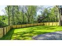 Expansive fenced backyard with lush green grass, perfect for outdoor activities at 112 Circle Dr, Salisbury, NC 28144
