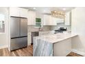 Modern kitchen with stainless steel appliances, island and granite countertops and a stylish light fixture at 112 Circle Dr, Salisbury, NC 28144