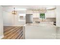 Bright kitchen featuring an island with granite countertops, stainless steel appliances and hardwood floors at 112 Circle Dr, Salisbury, NC 28144