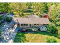 Aerial shot of brick home with carport, mature trees, and colorful front yard landscaping at 113 Princess Ln, Dallas, NC 28034