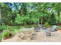 Inviting backyard patio with outdoor dining set, fire pit, and cozy seating for relaxation at 1202 Foxfield Rd, Waxhaw, NC 28173