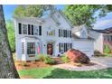 Charming white two-story home with black shutters, well-maintained lawn and brick-lined driveway at 1202 Foxfield Rd, Waxhaw, NC 28173