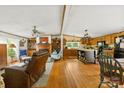Spacious living room with hardwood floors, a fireplace, and seamless transition to an open kitchen at 124 Neumann Run, Belmont, NC 28012