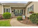 Inviting front porch with cozy seating and welcoming decor, and attractive landscaping at 15 Willow Oaks Ct, Taylorsville, NC 28681