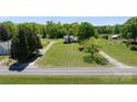 Sprawling aerial view of the home with a long driveway, surrounded by lush greenery and mature trees at 155 Jackson Rd, Salisbury, NC 28146