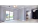 Cozy living space with light walls, plush carpeting, and sliding glass door with access to outdoor greenery at 1716 Termini Dr, Charlotte, NC 28262