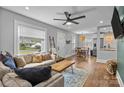Cozy living room flowing into dining area, featuring hardwood floors, comfortable seating, and ample natural light at 1913 Garibaldi Ave, Charlotte, NC 28208