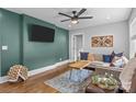 Relaxing living room boasts modern decor, hardwood floors, a comfortable sofa, and a wall-mounted television at 1913 Garibaldi Ave, Charlotte, NC 28208