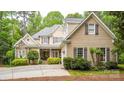 Inviting exterior showcasing a stone facade, tan siding, and a well-maintained front yard at 19729 Callaway Hills Ln, Davidson, NC 28036