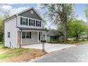 Side view of a charming two-story home with gray siding, complemented by a well-maintained driveway and landscaping at 213 Rosemont Ave, Kannapolis, NC 28081