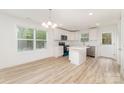 Bright kitchen featuring white cabinets, stainless steel appliances, and an island perfect for food preparation and casual dining at 213 Rosemont Ave, Kannapolis, NC 28081