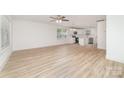 Open-concept living space featuring laminate flooring, offering a seamless flow into the kitchen for modern living at 213 Rosemont Ave, Kannapolis, NC 28081