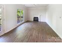 Bright living room with fireplace, hardwood floors and backyard views at 2405 Kalis Pl, Charlotte, NC 28262