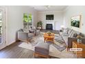 Bright living room with fireplace, plush seating, area rug and backyard views at 2405 Kalis Pl, Charlotte, NC 28262
