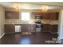 Spacious kitchen with stainless steel appliances, granite countertops, and hardwood flooring at 2440 Mint Thistle Ct, Charlotte, NC 28269