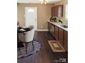 Eat-in kitchen featuring stainless steel appliances, granite countertops, and hardwood flooring at 2440 Mint Thistle Ct, Charlotte, NC 28269