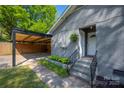 Exterior view of carport and entrance on gray brick home at 2601 Dora Dr, Charlotte, NC 28215