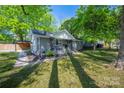A beautifully landscaped front yard showcases a charming home with mature trees and a classic design at 2601 Dora Dr, Charlotte, NC 28215