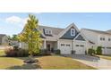 Charming two-story home featuring blue and gray siding, a two-car garage, and a well-manicured front yard at 2704 Watergarden St, York, SC 29745