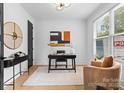 Well-lit home office with a modern desk, comfortable seating, and stylish decor at 3256 Brixton Ct, Charlotte, NC 28205