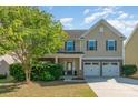 Charming two-story home featuring a stone-accented facade, well-manicured lawn, and a two-car garage at 3912 Franklin Meadows Dr, Matthews, NC 28105