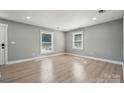 Cozy bedroom featuring sleek flooring, neutral paint, and windows that bring in natural light at 500 Dedmon Dr, Charlotte, NC 28216
