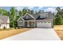 Stylish gray two-story home with white trim and a convenient two-car attached garage at 5162 Beckenham Ln, Concord, NC 28025